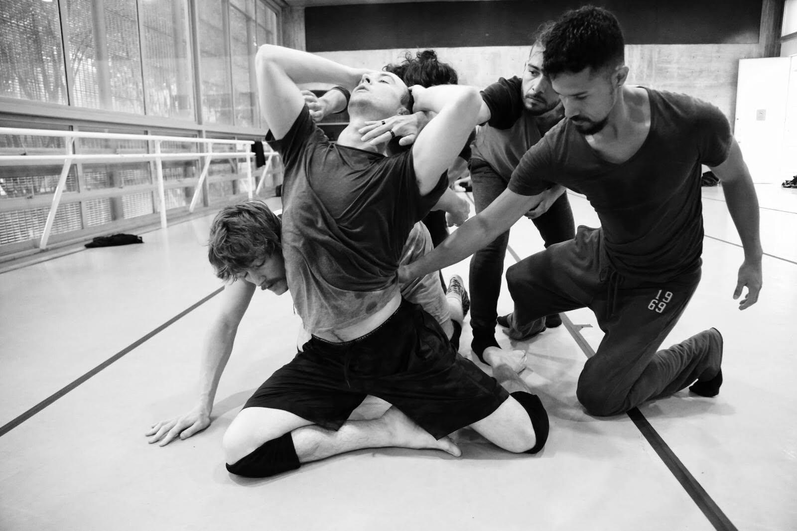 Matthew Moore moving within a group rehearsal