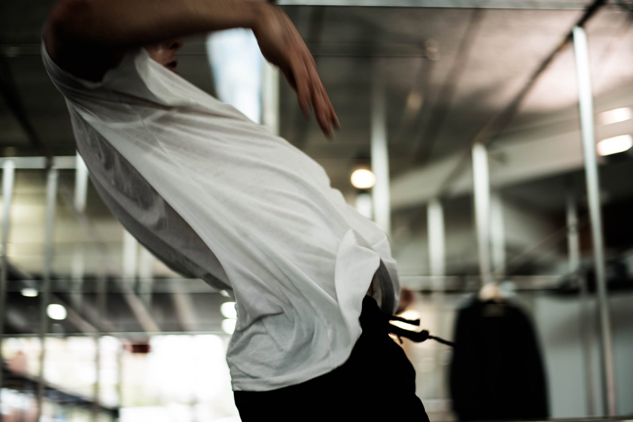 Performer creating a sculptural form with white fabric